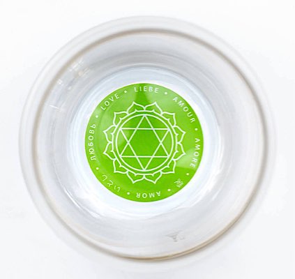 Green Heart Chakra symbol on the base of glass with Harmony as the heart's affirmation